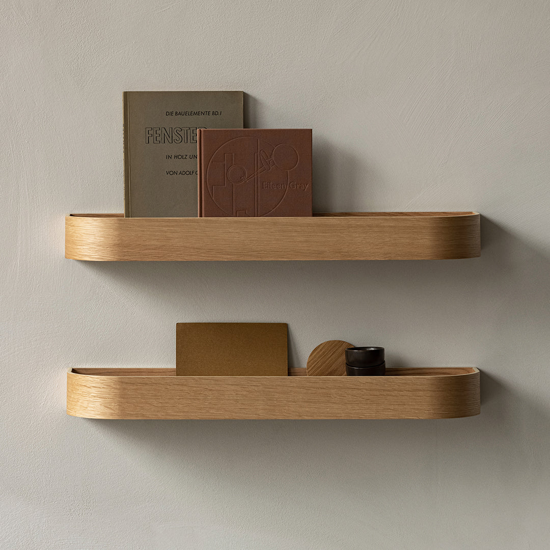 Light oak wood floating shelves with smooth edges, featuring a natural finish and minimalist design, showcasing neutral book colors.
