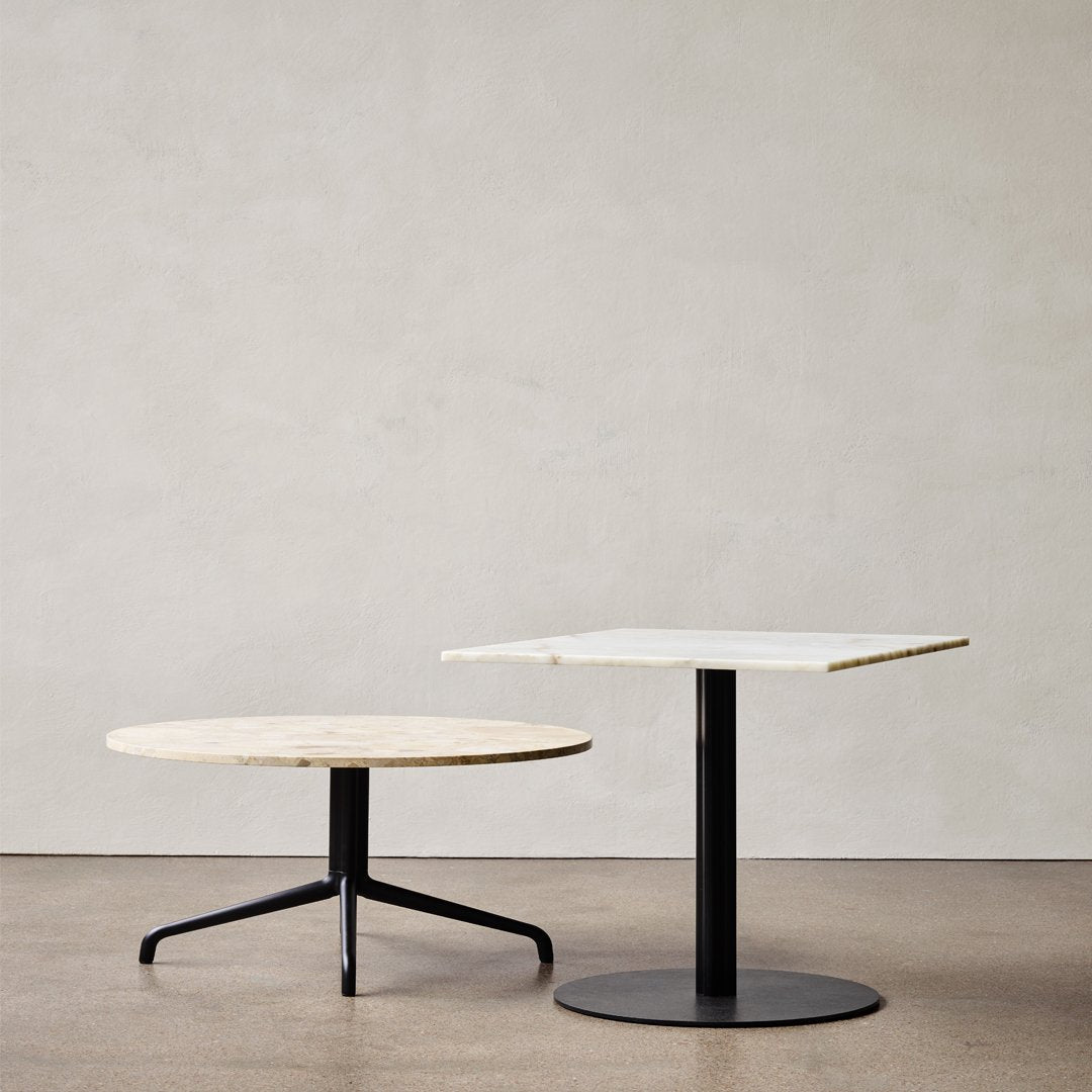 Modern coffee tables featuring natural wood and sleek black metal bases, with minimalist round and square designs.