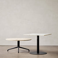Modern coffee tables featuring natural wood and sleek black metal bases, with minimalist round and square designs.