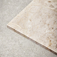 Beige marble tabletop with subtle veining patterns, featuring a smooth, polished finish. Ideal for stylish decor.