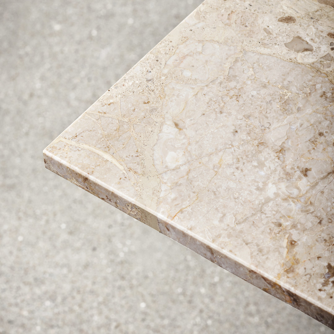 Light beige marble with subtle veining and a polished finish, showcasing natural patterns and textures.