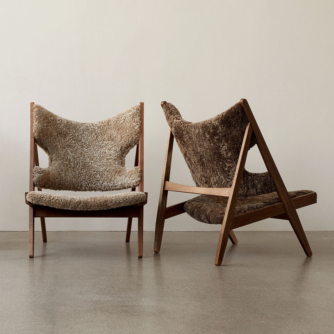 Rustic two-tone chairs in soft cream and rich brown with textured, cozy upholstery and wooden frames.