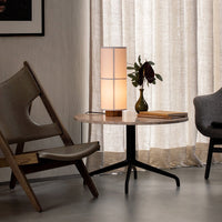 Neutral tones with soft beige patterns, featuring a sleek white lamp and dark-colored furniture accents.