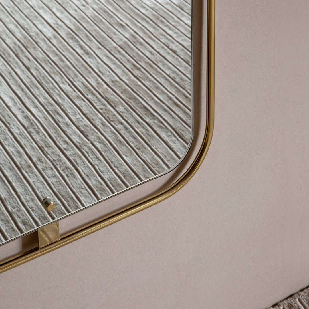Close-up of a textured cream surface with gold curved edges and a striped beige background. Elegant modern design.
