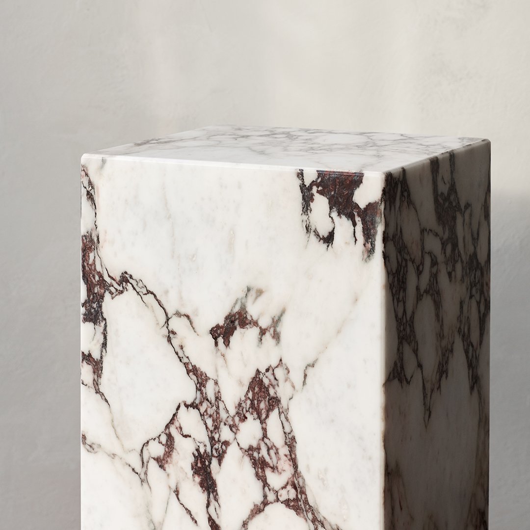 White marble cube with rich brown veining pattern, showcasing a modern, elegant design perfect for home decor.