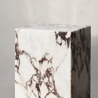 White marble cube with rich brown veining pattern, showcasing a modern, elegant design perfect for home decor.