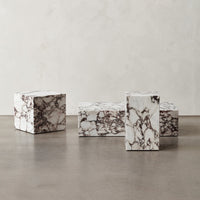 White marble blocks with striking dark veining, showcasing a modern, elegant pattern. Ideal for decorative use.