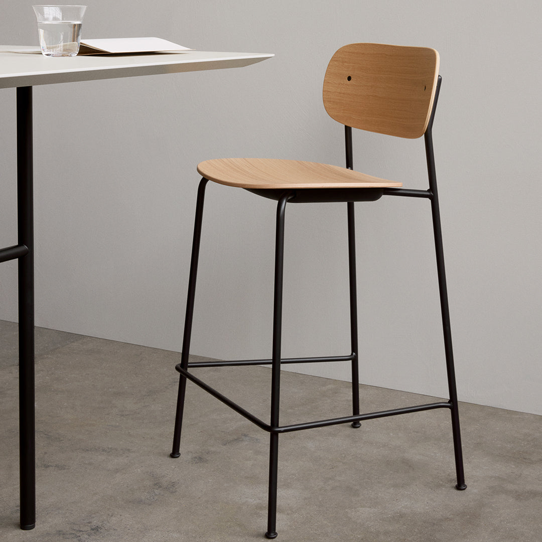 Wooden bar stool with a light brown seat and black metal frame, featuring a minimalist design and smooth finish.