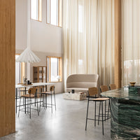Modern space featuring soft beige curtains, marble green countertop, and minimalist wooden accents. Elegant and serene ambiance.