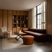 Modern living room featuring earthy tones, textured fabrics, and a mix of brown, beige, and warm wood accents.