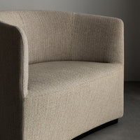 Beige textured upholstery with subtle flecks, curved design showcasing minimalist elegance.