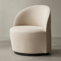 Cream-colored swivel chair with a smooth, soft texture and minimalist design, featuring a round shape and black base.