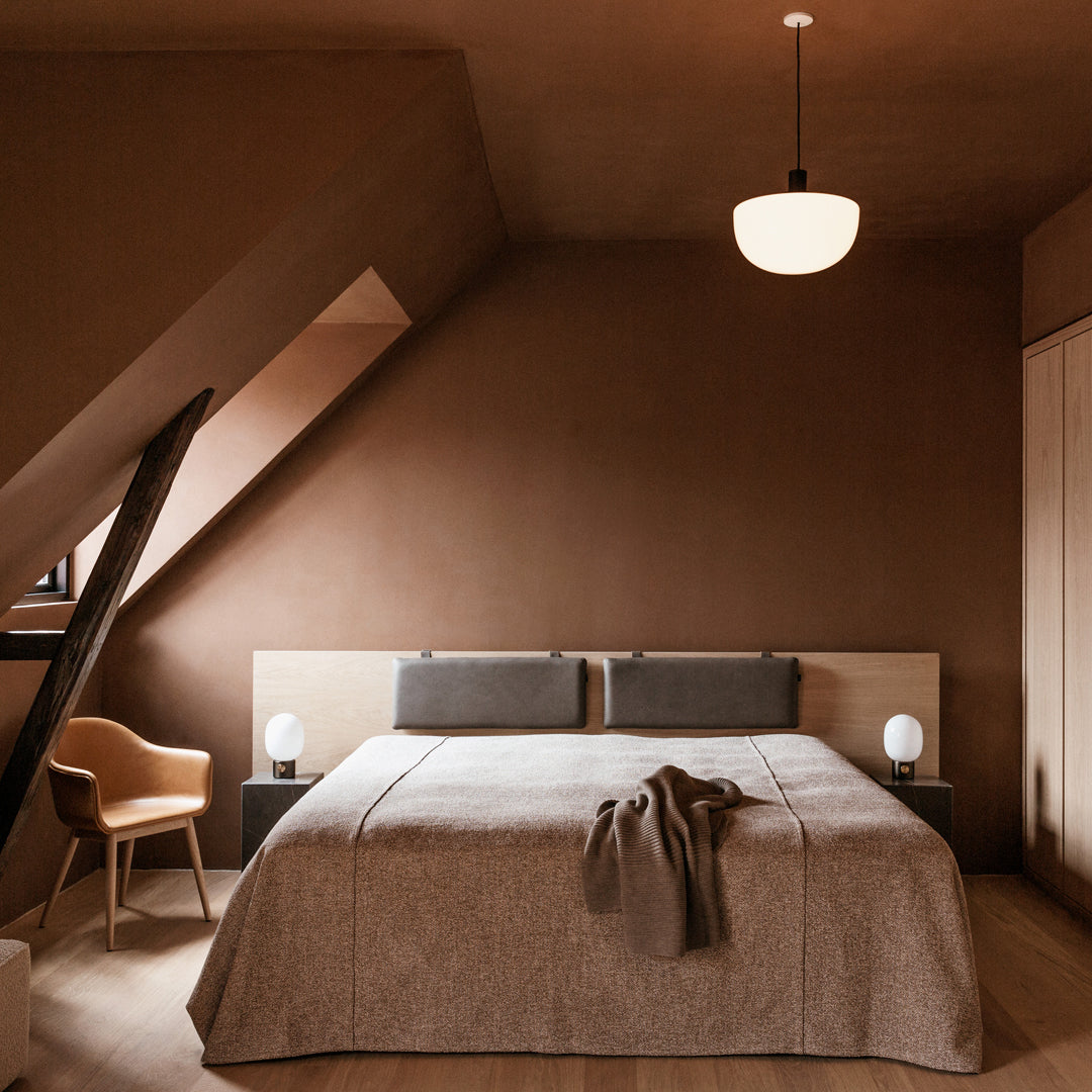 Cozy brown bedroom with textured beige bedding and soft neutral accents, creating a warm and inviting atmosphere.