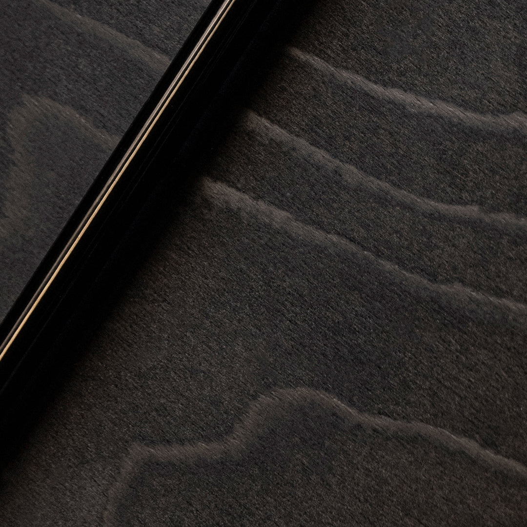 Sleek black finish with subtle gray waves contrasting against a textured dark background. Perfect for modern aesthetics.