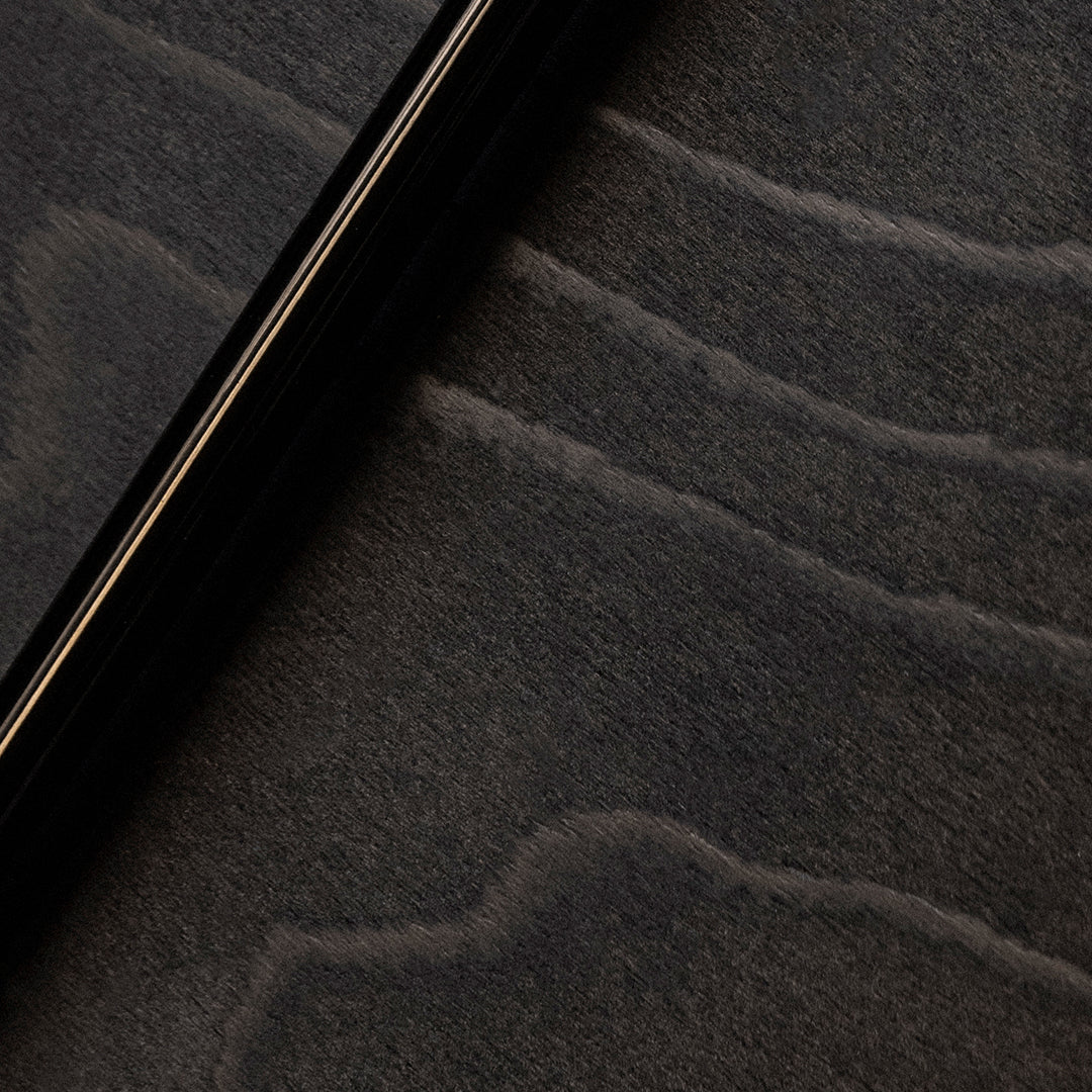 Black surface with subtle gray wave patterns, creating a modern and elegant aesthetic.