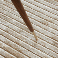 Beige striped texture with a smooth, plush surface and wooden leg detail. Soft and modern. Perfect for cozy spaces.