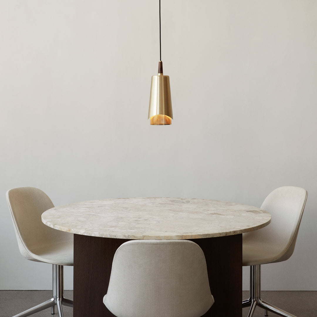 Gold pendant light above a round marble table with a dark brown base, complemented by modern white chairs.
