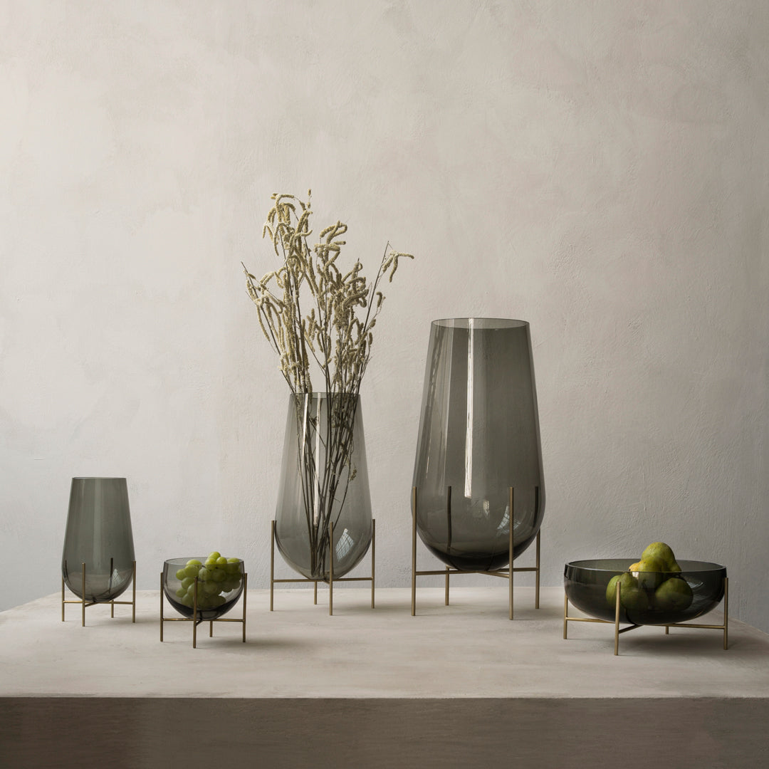 Set of five sleek gray glass vases with gold accents, featuring smooth and elegant designs. Perfect for any decor.