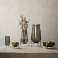 Set of five sleek gray glass vases with gold accents, featuring smooth and elegant designs. Perfect for any decor.