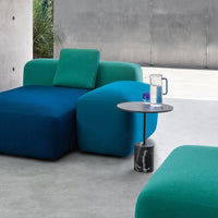 Modern sectional sofa in vibrant teal and deep blue hues, featuring smooth texture and minimalistic design.