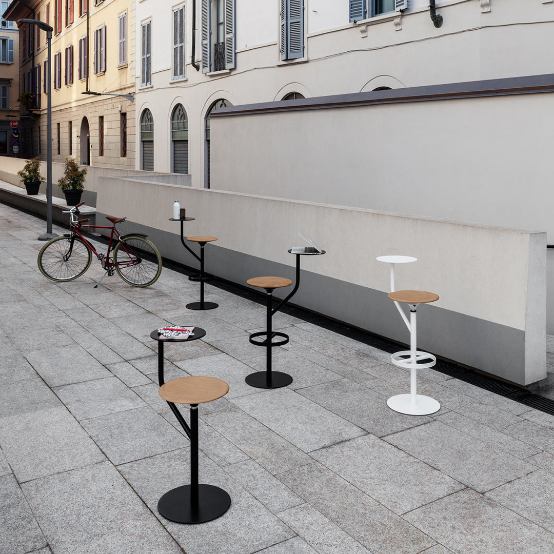Colorful outdoor bar stools featuring black, white, and natural wood patterns, set against a stylish urban backdrop.