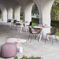 "Modern outdoor dining setup featuring white, grey, and soft pink tones with clean lines and minimalistic patterns."