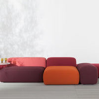 Colorful modern sofa featuring shades of purple, pink, and orange with a smooth, seamless design. Perfect for vibrant decor.