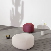 Minimalist poufs in cream and burgundy, featuring soft textures against a neutral backdrop.