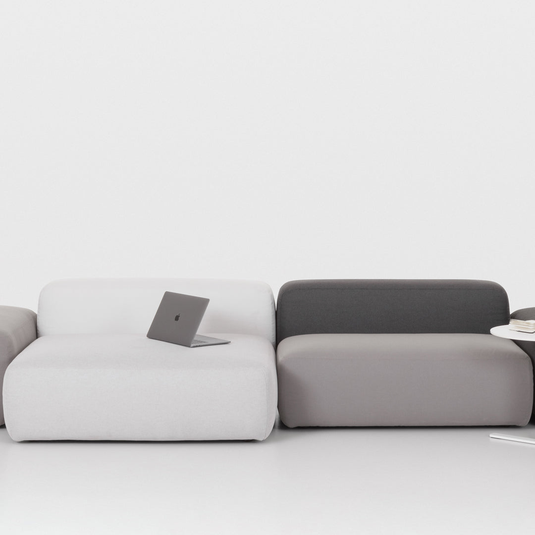 Modern sectional sofa featuring a sleek design in white, light gray, and dark gray upholstery. Ideal for contemporary decor.