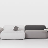 Modern sectional sofa featuring a sleek design in white, light gray, and dark gray upholstery. Ideal for contemporary decor.