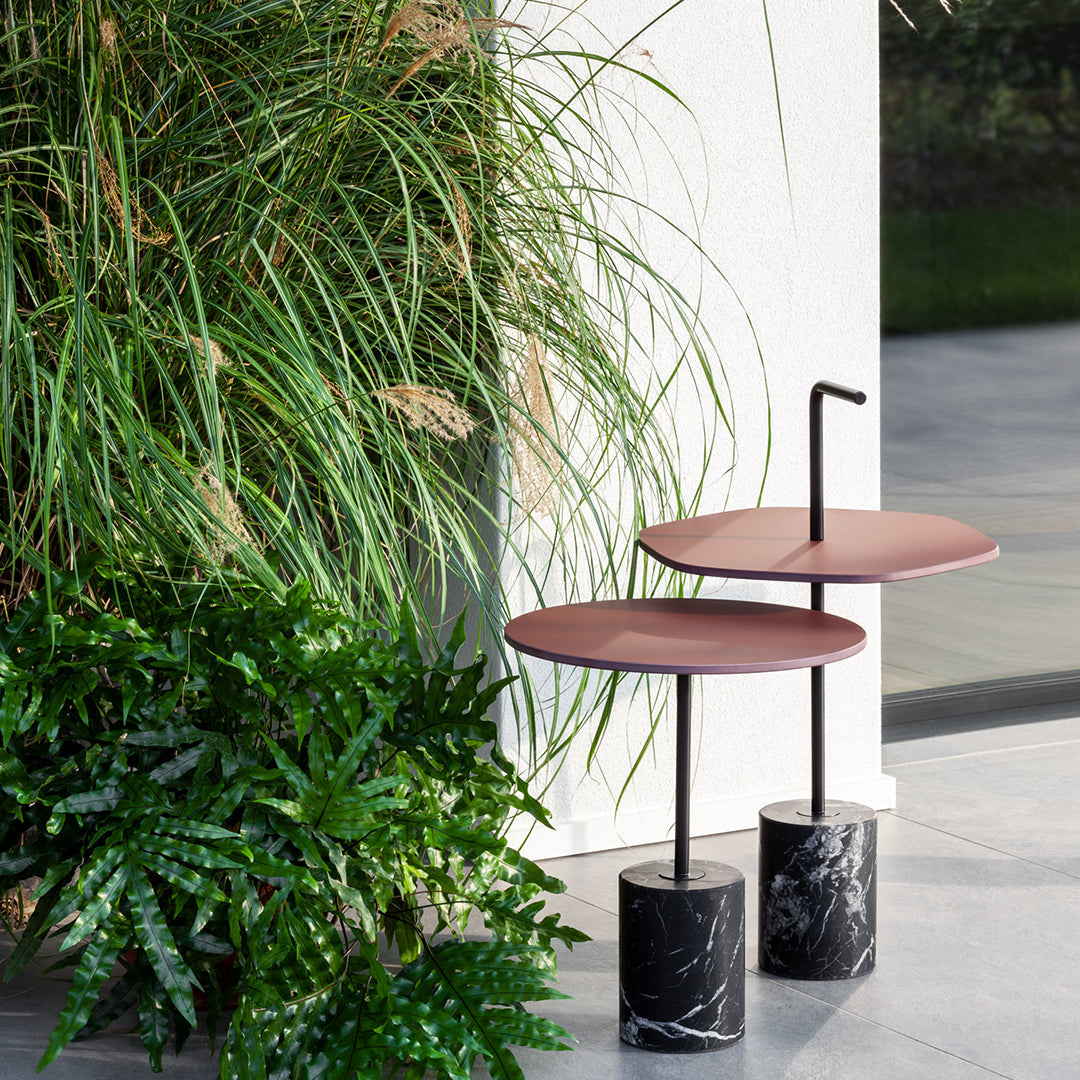 Stylish two-tier side tables in deep red and black marble, featuring a modern design with sleek lines.