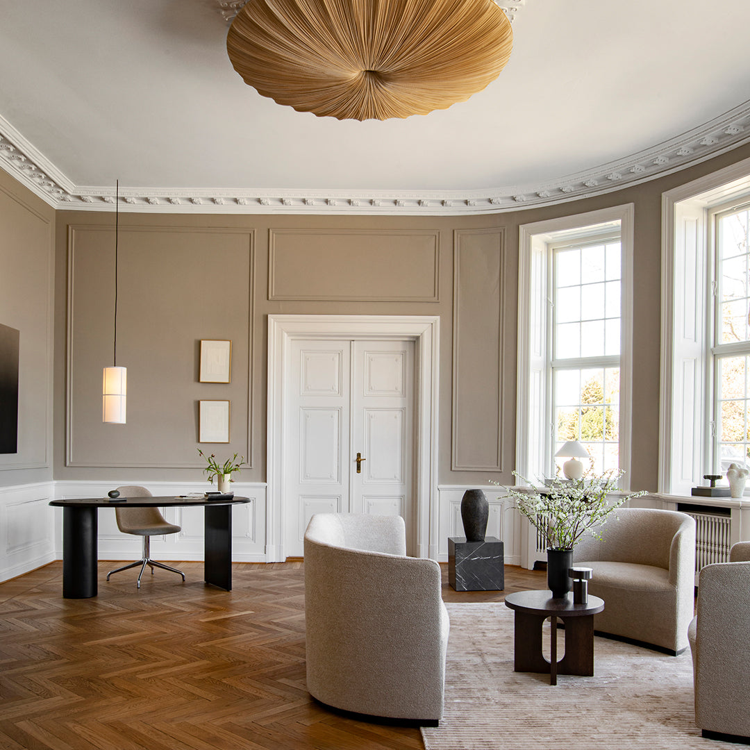 Elegant beige walls, dark wood accents, and a warm, natural light create a sophisticated and inviting interior space.