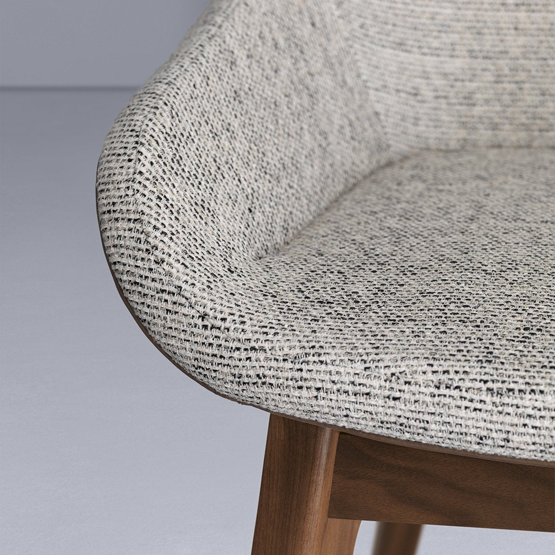Textured gray and beige upholstery pattern on a modern chair, featuring a smooth, stylish finish.