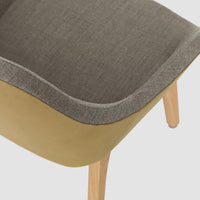 Gray and beige patterned chair with wooden legs, showcasing a modern and minimalistic design.