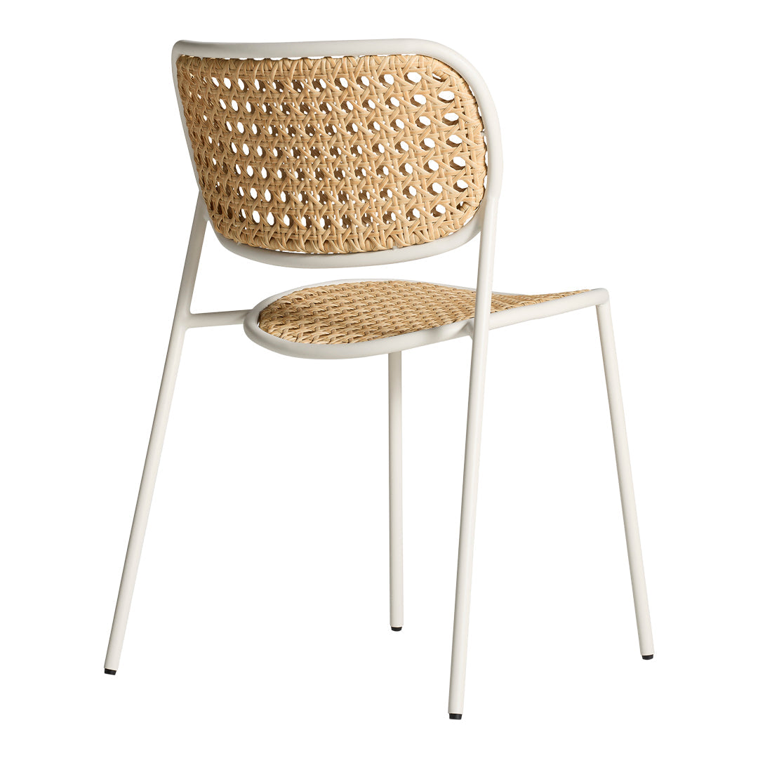 Woven rattan chair in natural tones with a white metal frame, showcasing a minimalist design and intricate pattern.
