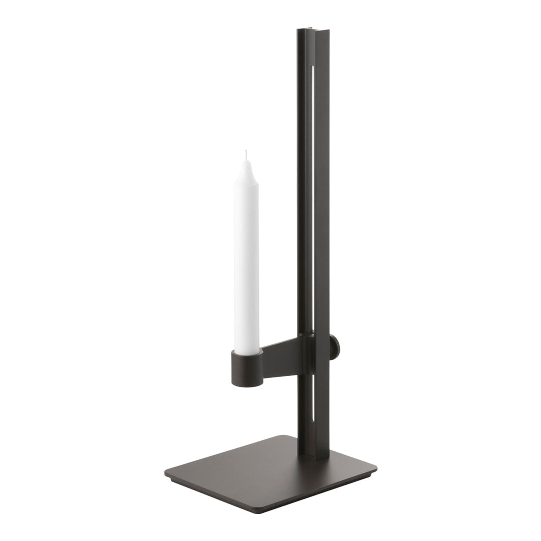 Black metal candle holder with a sleek, modern design and a simple white candle.