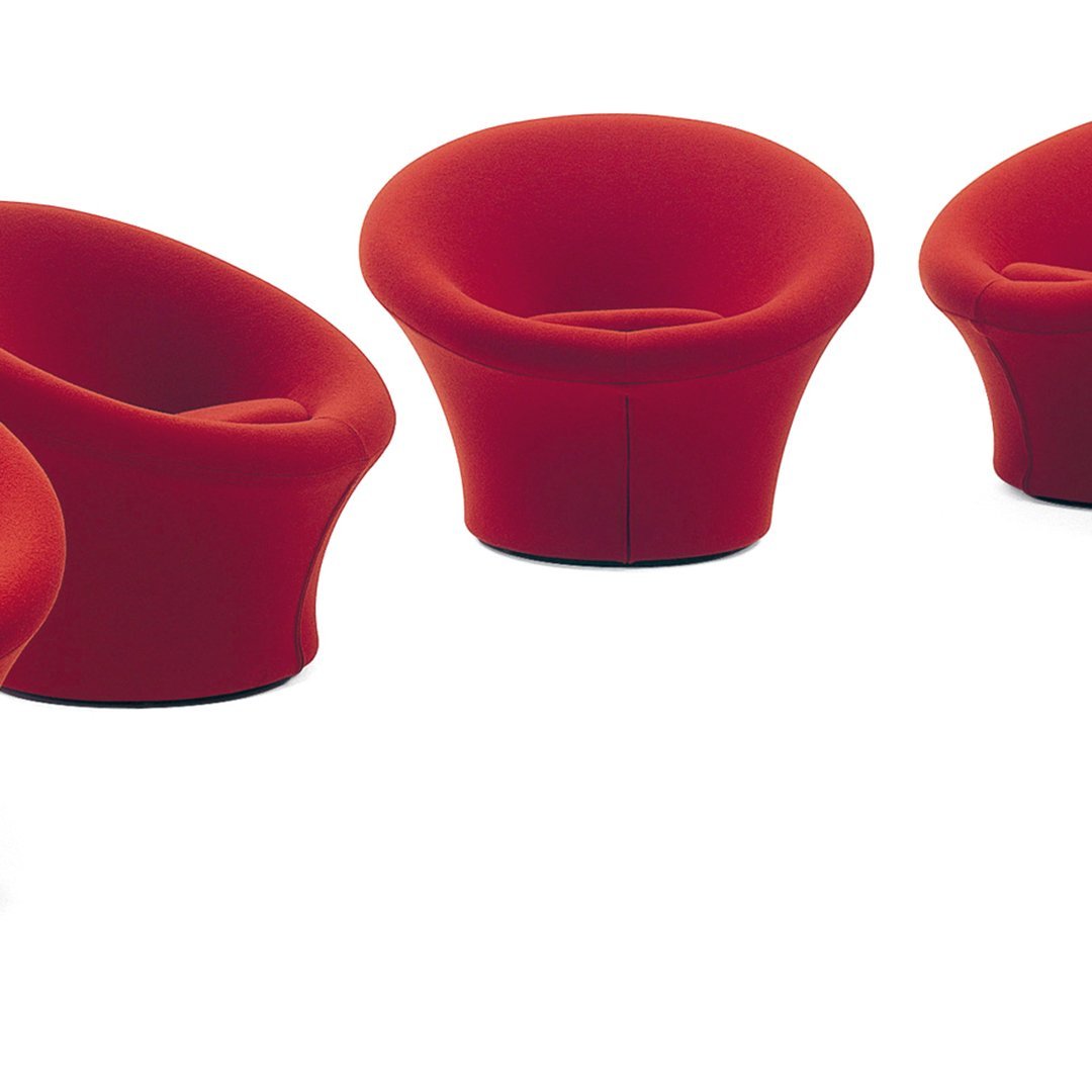Set of four vibrant red modern chairs with smooth, curved designs and a minimalist aesthetic.