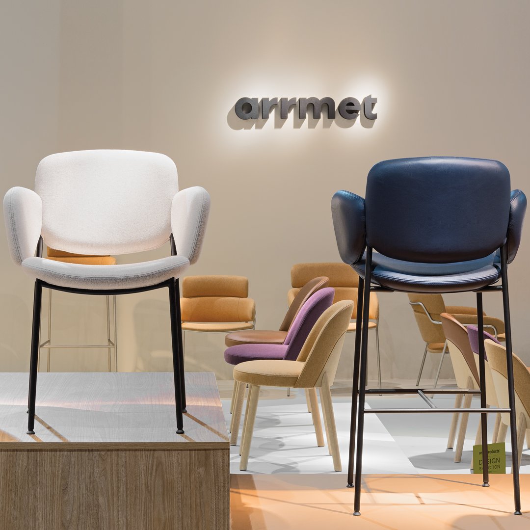 Stylish white and navy chairs with sleek black legs, set against a neutral backdrop, showcasing contemporary design.