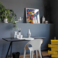 Colorful geometric artwork on a gray wall, featuring white, black, orange, and bright yellow accents.