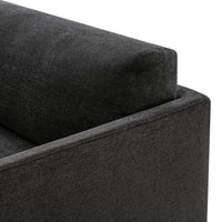 Textured dark gray fabric corner of a modern sofa with clean lines and minimalistic design. Ideal for contemporary decor.