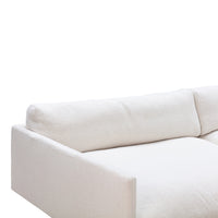 Minimalist white sectional sofa with a soft, textured fabric and clean lines, perfect for modern interiors.