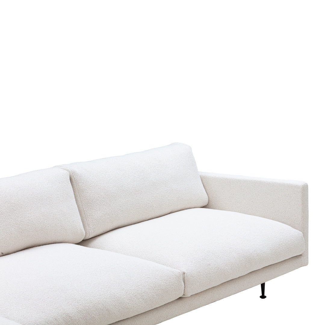 Stylish white modern sofa featuring a minimalist design and soft, textured fabric upholstery.