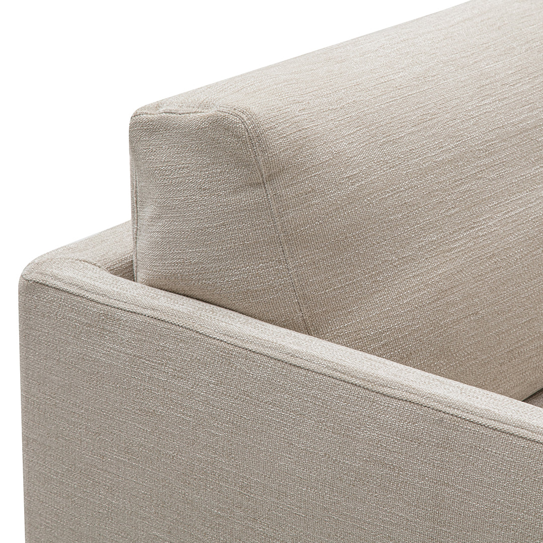 Beige textured fabric sofa with subtle woven pattern, featuring clean lines and modern design elements.