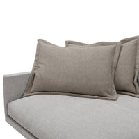 Gray sofa with soft, textured fabric and light brown accent pillows, perfect for a modern decor aesthetic.