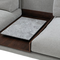 Gray marble top on a wood base, surrounded by soft gray upholstery, highlighting sleek, modern design.