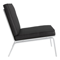 Black padded lounge chair against a sleek white frame, featuring a minimalist design with clean lines.