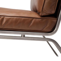 Brown leather accent chair with smooth texture and sleek silver metal frame. Modern design perfect for any space.