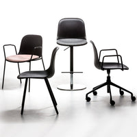 Set of four chairs featuring black, light pink, and sleek metallic finishes with modern, minimalist designs.