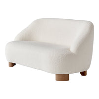 White boucle loveseat with soft curves and natural wood legs, adding a cozy, modern touch to any space.