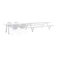 White minimalist dining table with sleek lines and matching white chairs, perfect for modern decor.